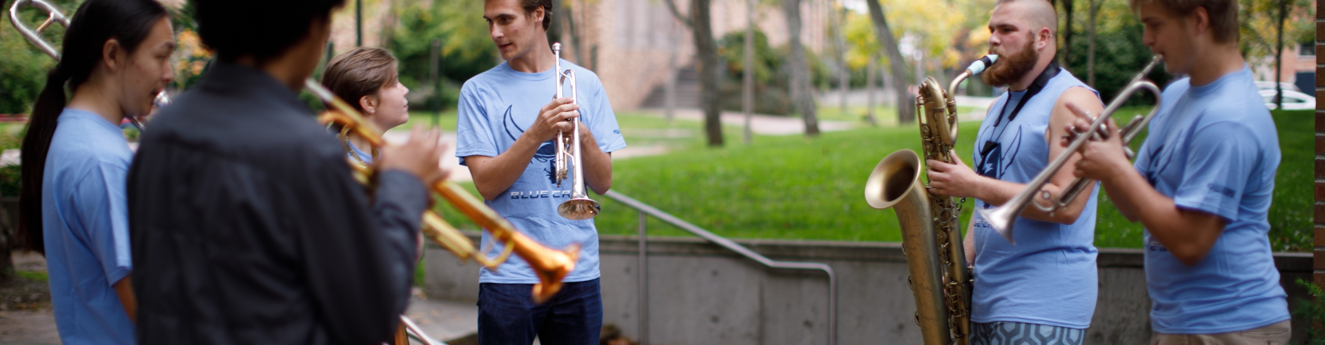 Students playing instruments in front of Old Main during Paint Bellingham Blue
