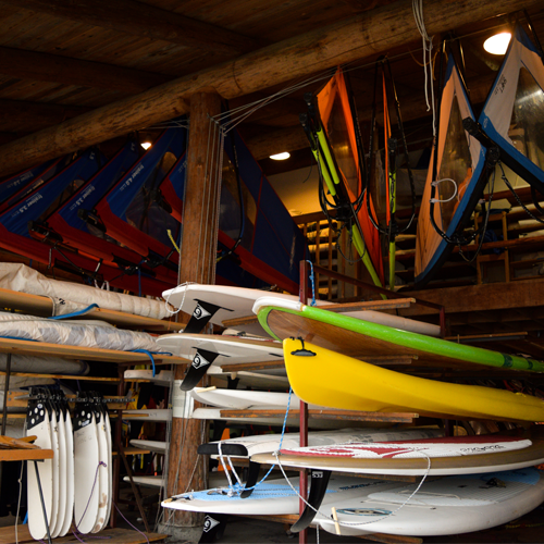 sup boards and sails in outdoor storage