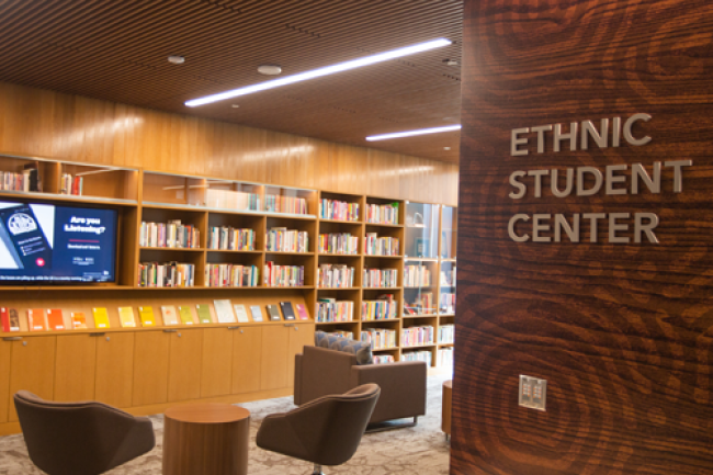 Ethnic Student Center lettering on wall looking at bookshelf